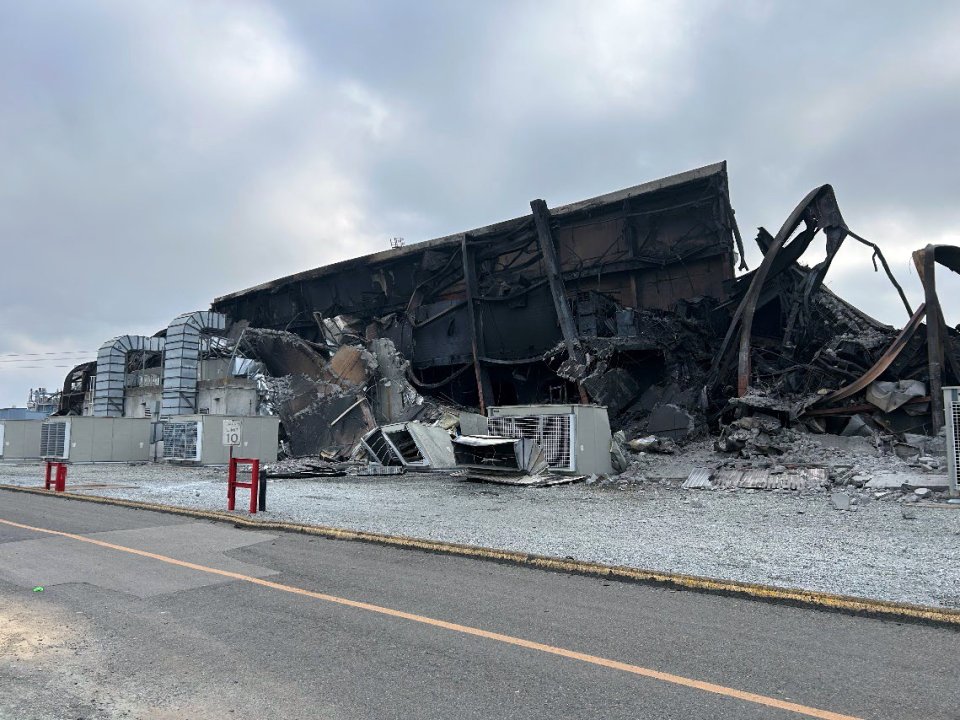 Exterior view of the burned ML300 building section at the Moss Landing Vistra battery fire response